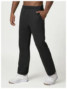 Detailed close-up view of men's black loose-fit casual sports sweatpants on a model