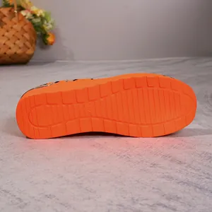Detail view showing the textured orange non-slip sole of leopard print mesh casual shoes.