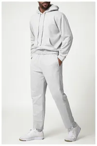 Full view of the relaxed fit and texture of the grey cotton tracksuit on a male model.