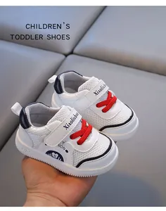 Close-up of white toddler mesh walking shoes with red laces and navy accents