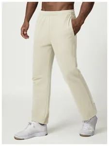 Full body view of men's cream relaxed-fit sweatpants for a casual urban citywalk style