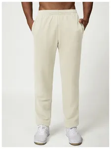 Front view of men's loose beige sweatpants with elastic waistband and pockets
