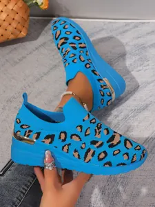 Blue leopard print flying knit wedge sneakers with round toe and gold detail