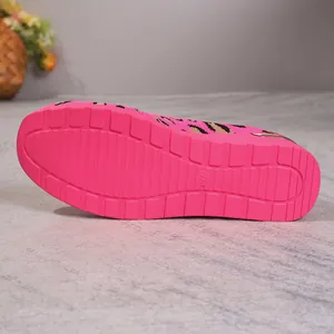Detailed macro shot of the bright pink textured sole on leopard print knit flat shoes