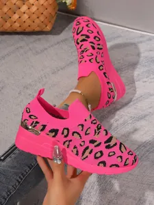 Close-up detail showing the texture of women's neon pink leopard print sneakers