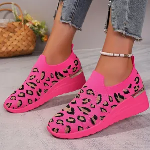 Detailed view of pink leopard print mesh slip-on wedge sneakers for women on feet