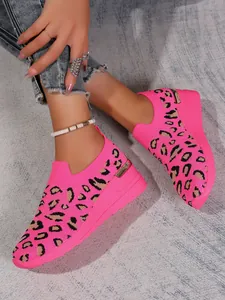 Detail shot of pink leopard print flyknit wedge sneakers with metallic heel trim
