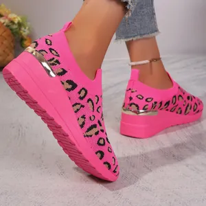 Close-up of pink leopard print fly-knit slip-on sneakers with gold heel detail
