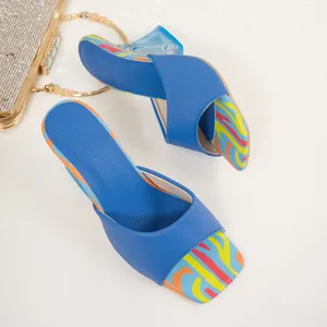 Detail of blue square-toe sandals with colorful patterns and crystal block heels