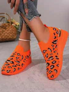 Bright orange flyknit sneakers with leopard print and wedge sole for women stylish look