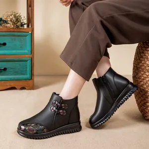 Schwarze Damen-Winterstiefeletten mit Fellfutter und traditionellem Blumenmuster.