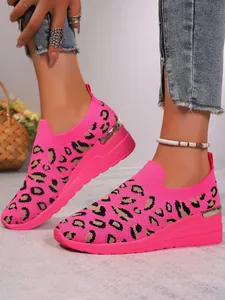 Bright pink leopard print wedge sneakers in breathable flyknit mesh fabric