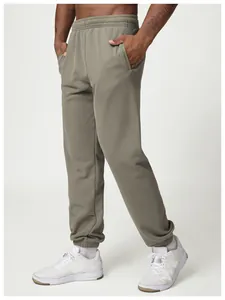 Detail of men's olive green jogger sweatpants with elastic waist and cuffed hem