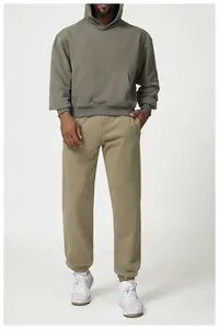 Close-up of men's casual khaki jogger sweatpants with elastic cuffs and pocket details.