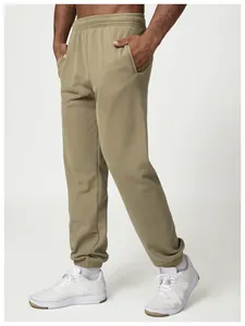 Detail shot of men's olive green joggers with elastic cuffs and side pockets