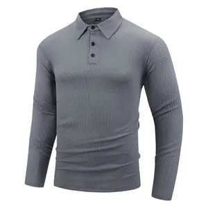 Detailed shot of grey long-sleeved polo shirt with textured jacquard pattern