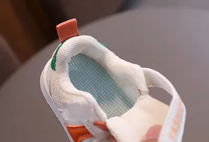 Macro view showing the breathable mesh lining and soft blue insole of toddler sneakers