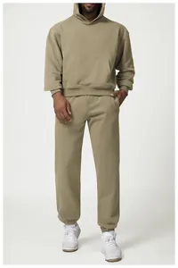 Full view of men's olive green hoodie and jogger sweatpants set with white sneakers