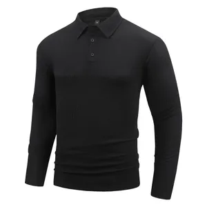 Detail view of men's black long-sleeved polo shirt featuring a textured waffle knit fabric