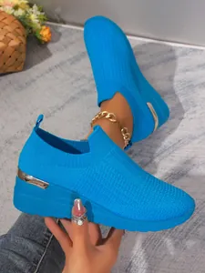 Breathable blue fly-knit mesh slip-on sneakers with wedge heel and metallic detail