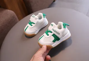 Detailed macro view of breathable toddler mesh walking shoes in white and green