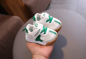 Detail view of breathable white and green toddler walking shoes with velcro straps