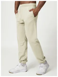 Detail view of men's light khaki joggers showing the soft fabric and elastic cuffs