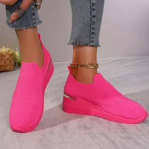 Vibrant pink flyknit wedge sneakers with comfortable breathable mesh and metallic heel detail