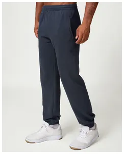 Detailed view of men's dark grey jogger sweatpants with elastic waist and side pockets
