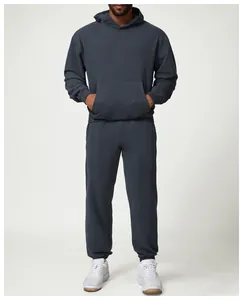 Full view of men's dark charcoal hoodie and jogger set shown on a professional model