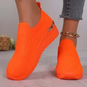 Bright neon orange knit slip-on casual walking sneakers featuring elegant gold heel detail