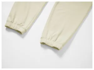 Close-up detail of beige men's casual joggers featuring elasticated ribbed cuffs