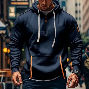 Close-up of men's navy blue tactical hoodie with orange zipper details and arm pocket