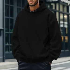 Detailed view of a men's classic black fleece hoodie with front kangaroo pocket in city.