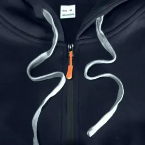 Detailed view of a black men's zipper hoodie showing M size tag and orange zipper puller