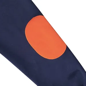 Close-up detail showing the navy blue sweatshirt sleeve with a contrast orange oval patch