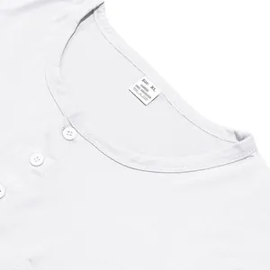 Detailed view of the white round neck long sleeve t-shirt collar and fabric material tag