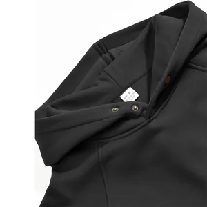 Detailed macro view of the neck label and fabric on a black men's fleece hoodie