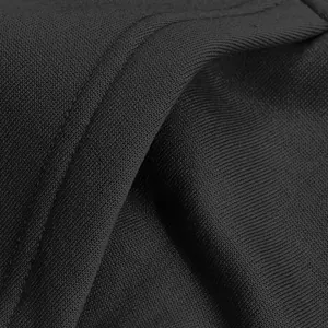 Macro detail of black fleece hoodie fabric showing high-quality knitted texture and stitching