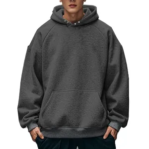 Close-up of men's dark grey fleece hoodie with snap buttons and kangaroo pocket details