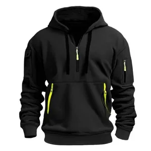 Detail of black fleece-lined hoodie with multi-zipper pockets and green accents