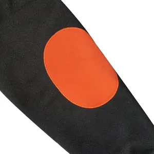 Close-up view of a heavy black sweatshirt sleeve with a vibrant orange oval elbow patch detail