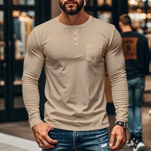 Macro view of men's slim fit khaki long sleeve Henley t-shirt with pocket detail