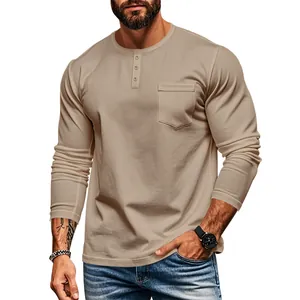 Detail of men's tan slim fit long sleeve Henley shirt with chest pocket and button neckline.