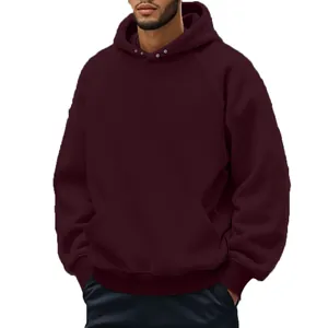 Close-up of premium maroon men's hoodie featuring raglan sleeves and a front kangaroo pocket