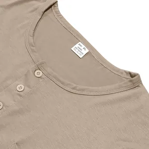 Detail view of a men's khaki long-sleeve Henley t-shirt featuring three front buttons.