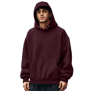 Macro detail of dark burgundy men's oversized fleece hoodie with hood snap button