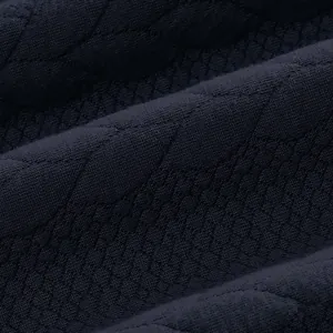 Detail shot of navy blue heavy sweatshirt fabric showing intricate jacquard texture