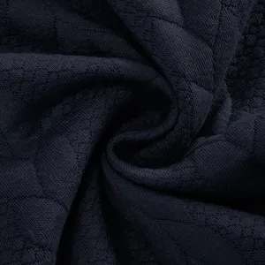 Macro detail of dark navy heavy jacquard fabric with honeycomb texture for men's sweatshirt