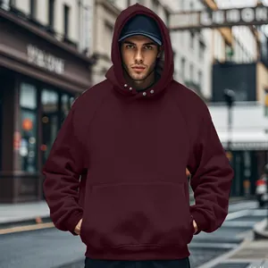 Close-up of maroon men's hooded sweatshirt with kangaroo pocket in a stylish urban street